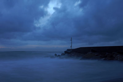 Scenic view of sea against cloudy sky