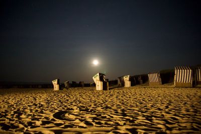 Scenic view of beach against clear sky at night