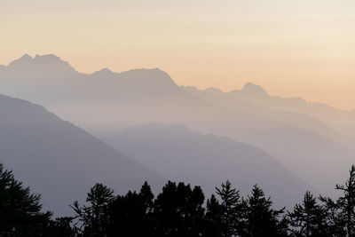 Scenic view of silhouette mountains against sky during sunset