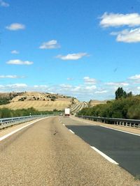 Road by landscape against sky