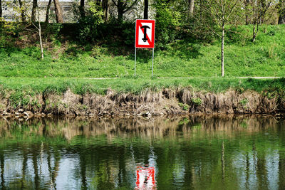 Sign board by lake