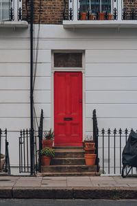 Bright red front door on a typical english terraced house in primrose hill, london, uk.