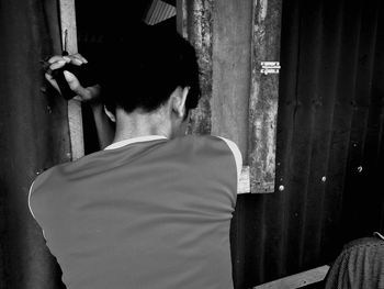 Rear view of two people standing on tiled floor