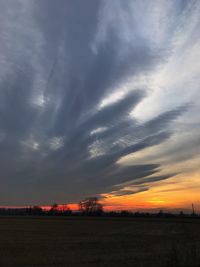 Scenic view of field against sky during sunset