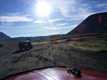 Scenic view of land and mountains against sky