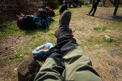 Low section of men relaxing on field