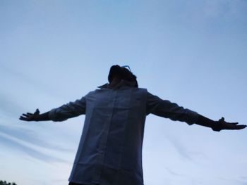 Low angle view of cross against sky