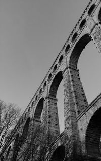 Low angle view of arch bridge against clear sky