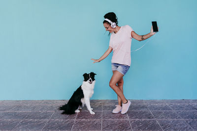 Full length of woman with dog