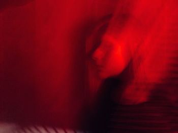 Close-up of woman with red light