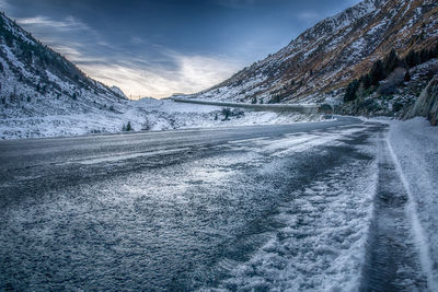 Snow covered landscape against sky