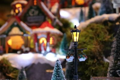 Close-up of illuminated lamp against temple