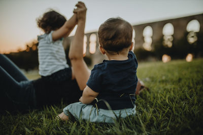 Mother with son and daughter on grass