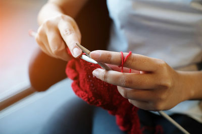 Close-up of woman knitting wool