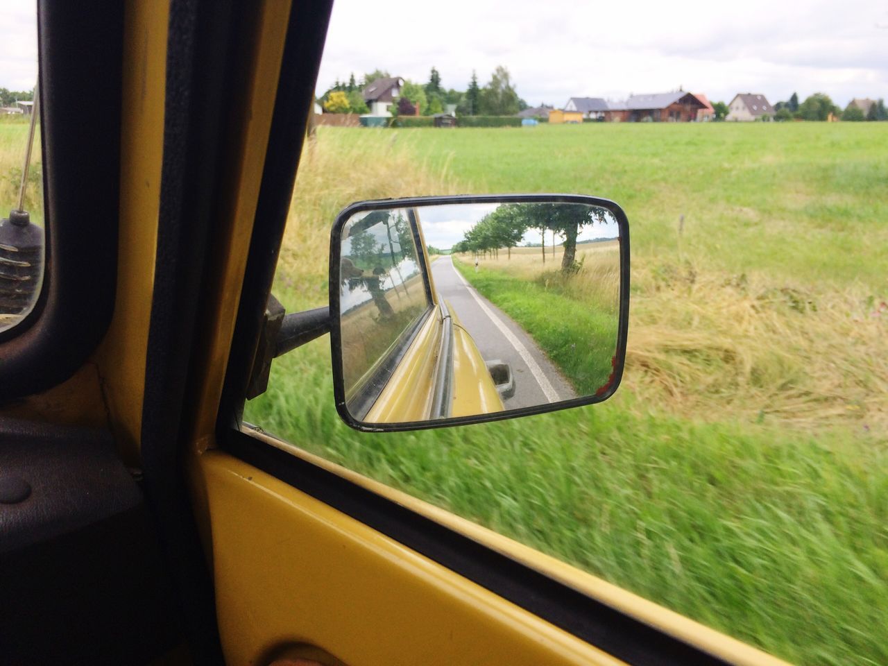 transportation, mode of transport, land vehicle, car, side-view mirror, vehicle interior, reflection, glass - material, grass, car interior, road, window, transparent, travel, part of, tree, field, close-up, cropped, windshield