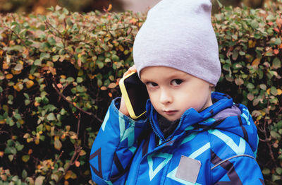 Portrait of a child with a phone in his hands who looks at the camera. communication concept. 