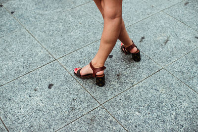 Low section of woman standing on tiled floor