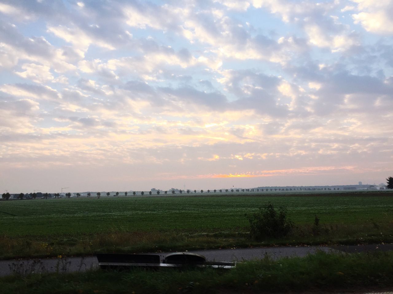 sky, cloud - sky, tranquil scene, sunset, field, tranquility, cloudy, scenics, landscape, beauty in nature, nature, grass, water, cloud, rural scene, agriculture, idyllic, weather, growth, tree