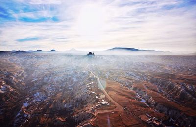 Scenic view of mountain range against cloudy sky