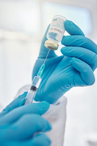 Midsection of scientist examining chemical in laboratory