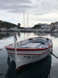 Sailboats moored on river against sky