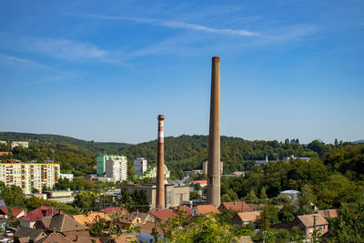 Built structure by building against blue sky