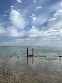 Lifeguard hut on beach against sky
