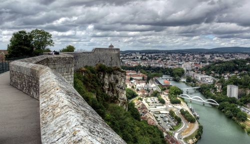 View of cityscape against cloudy sky