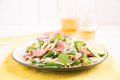 Close-up of salad and drinks on table