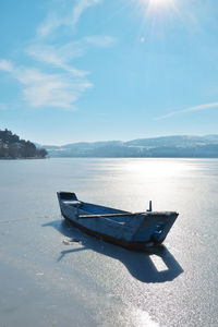 Boat in snowy lake of kastoria in greece