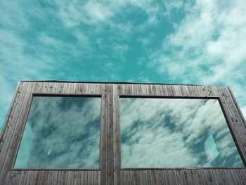 Low angle view of building against cloudy sky