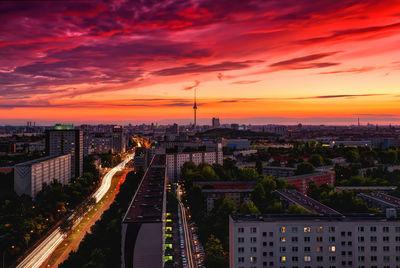 High angle view of illuminated cityscape against sky during sunset