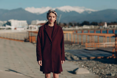 Portrait of young woman standing outdoors