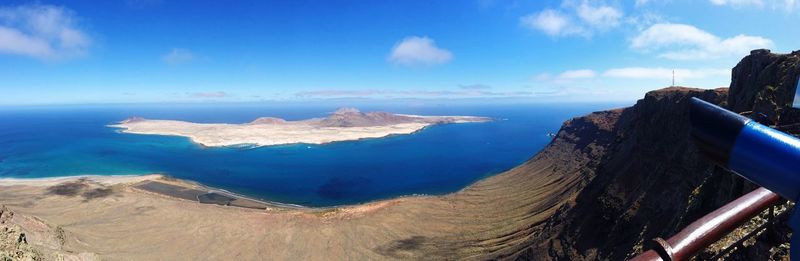 Panoramic view of volcanic landscape against blue sky