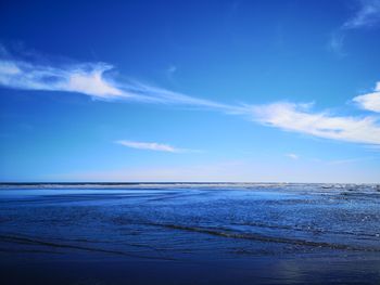 Scenic view of sea against blue sky