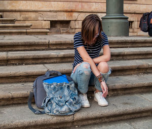 Full length of teenage girl sitting on steps