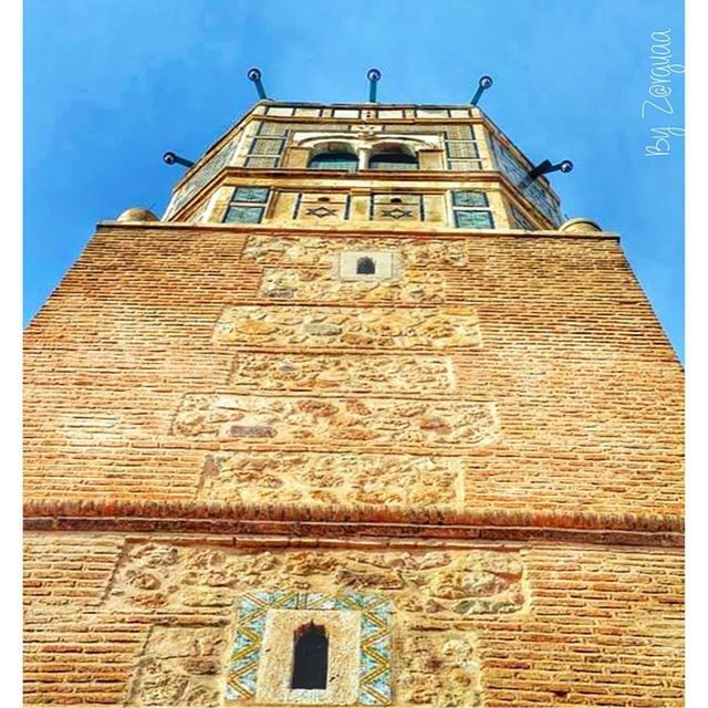 architecture, building exterior, built structure, low angle view, clear sky, blue, window, brick wall, tower, sunlight, history, old, sky, building, day, outdoors, wall - building feature, arch, no people, facade