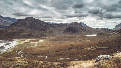 Scenic view of mountains against cloudy sky