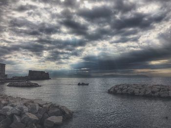 Scenic view of sea against cloudy sky