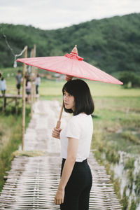 Full length of woman standing on rainy day