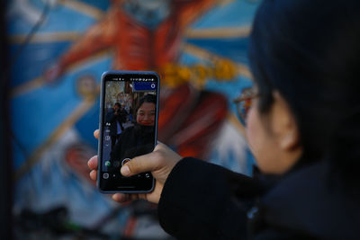 Side view of woman using mobile phone.