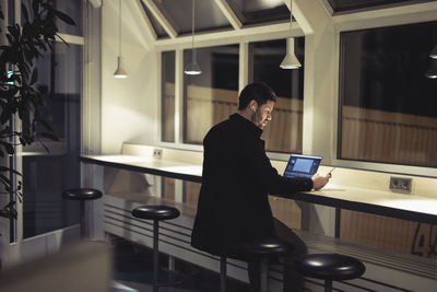 Man working with laptop in public space