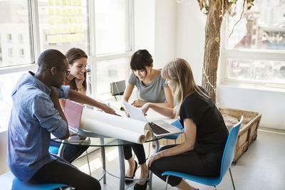 Creative business people discussing on table in office