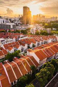 High angle view of buildings in city during sunset