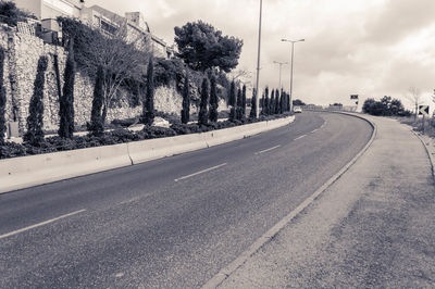 Empty road along the wall