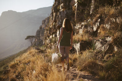 Rear view of woman standing on mountain