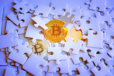 Close-up of bitcoins and jigsaw pieces