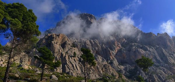 Panoramic view of rocky mountains against sky