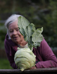 Portrait of granny, she  holding cabbage