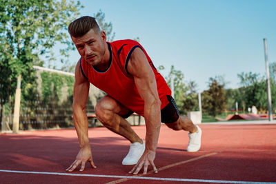 Side view of man exercising on road